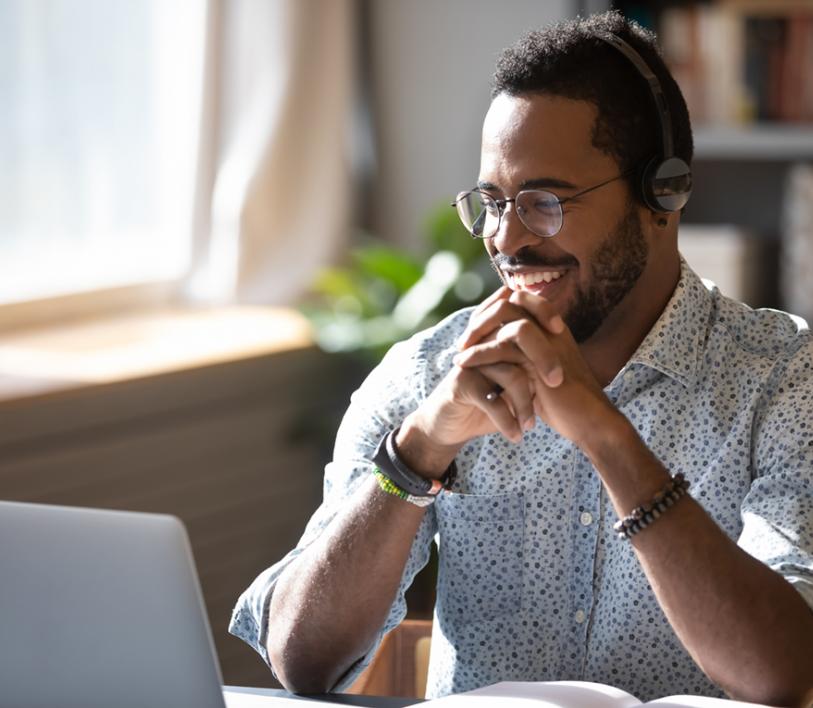 man smiling at laptop